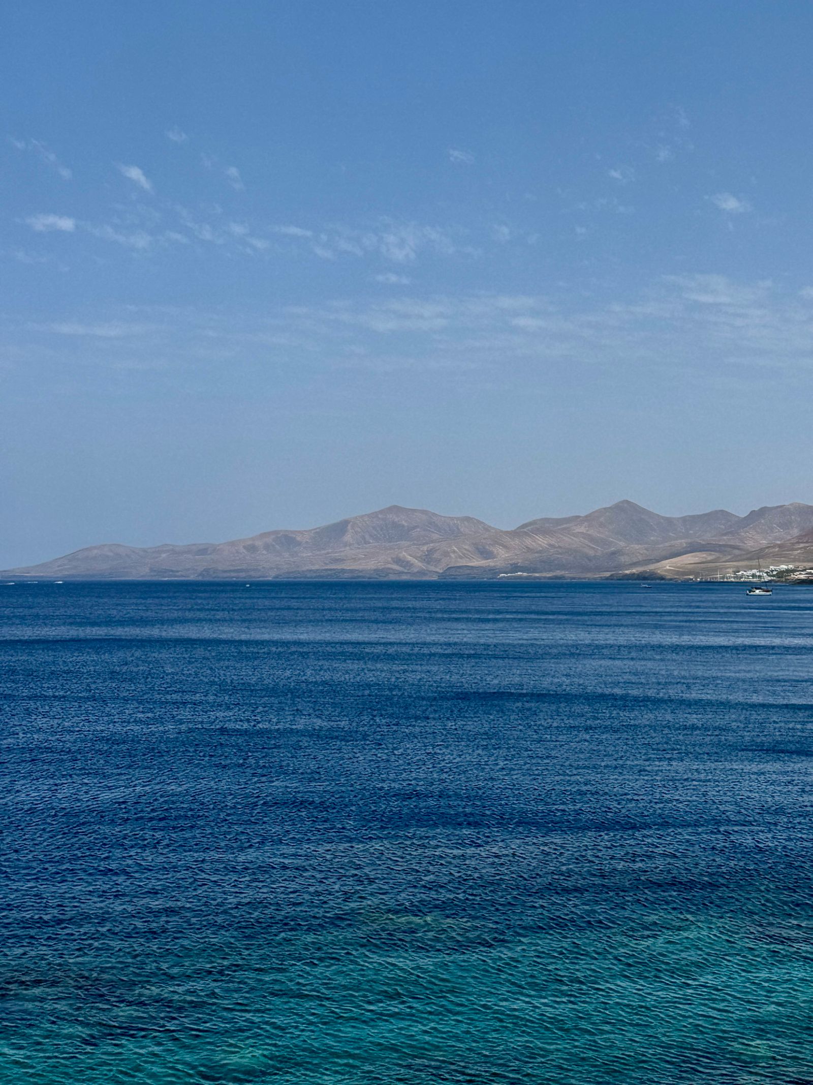 Ferry crossing from Órzola to La Graciosa with turquoise water and volcanic coastline