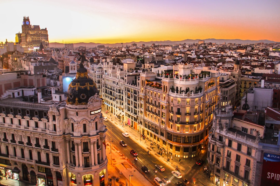 Spanish urban street with traffic and historic buildings
