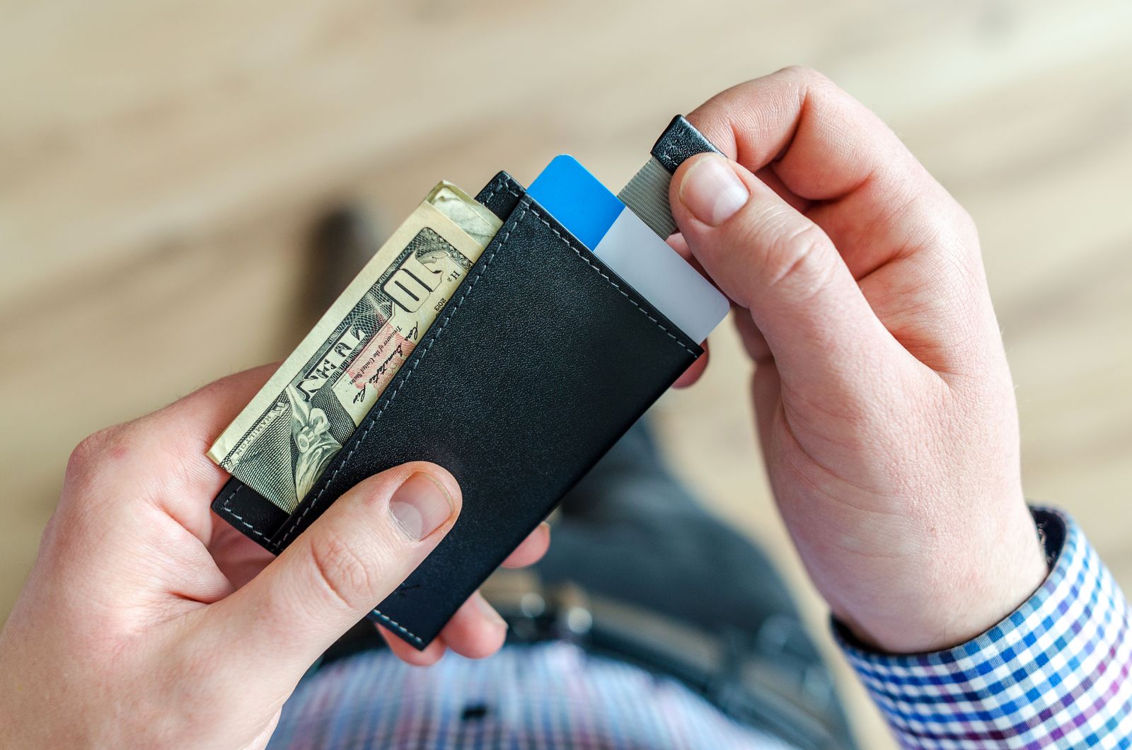 Wallet with cash and a debit card as an alternative to a credit card at a car rental counter
